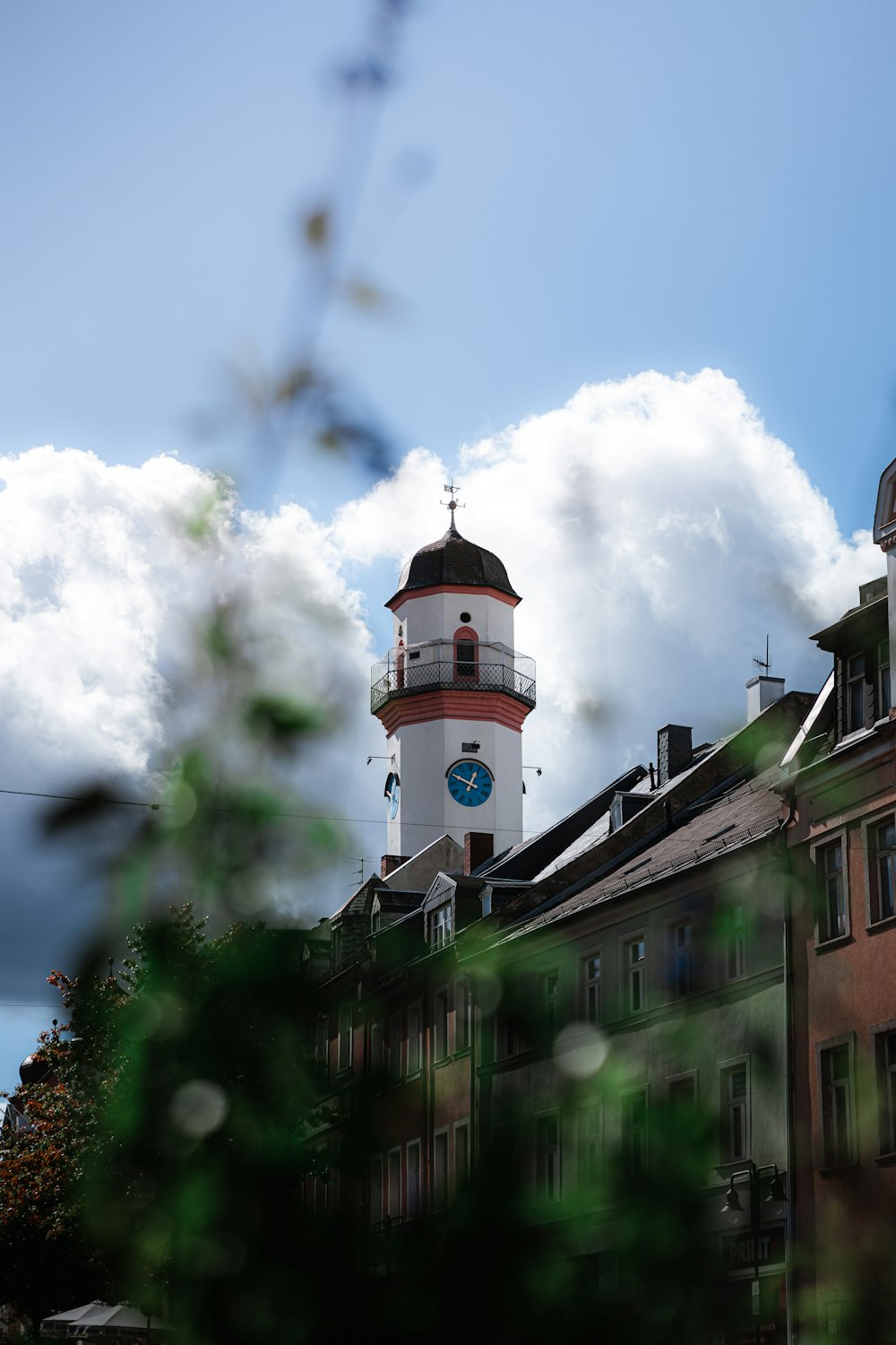 a white and red tower with a clock on it