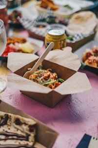 a table topped with boxes of food and drinks