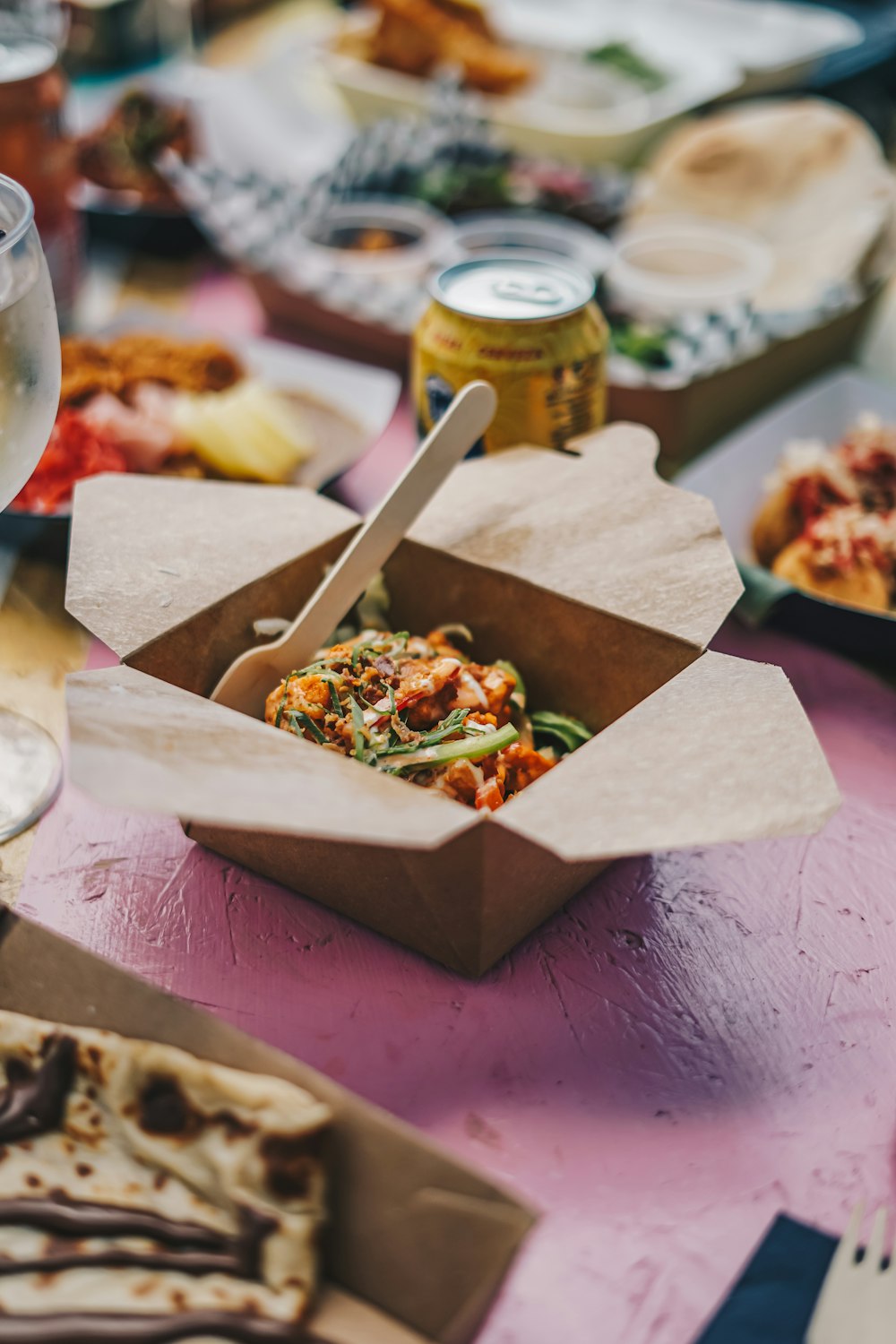 a table topped with boxes of food and drinks