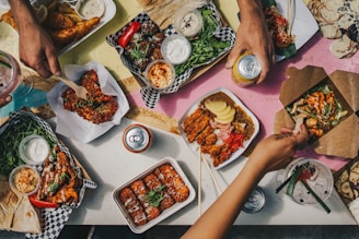 a group of people sitting around a table eating food