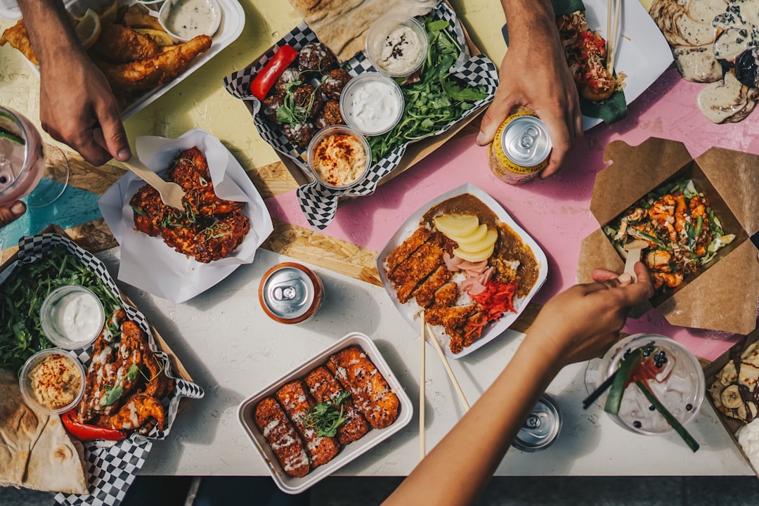 a group of people sitting around a table eating food,