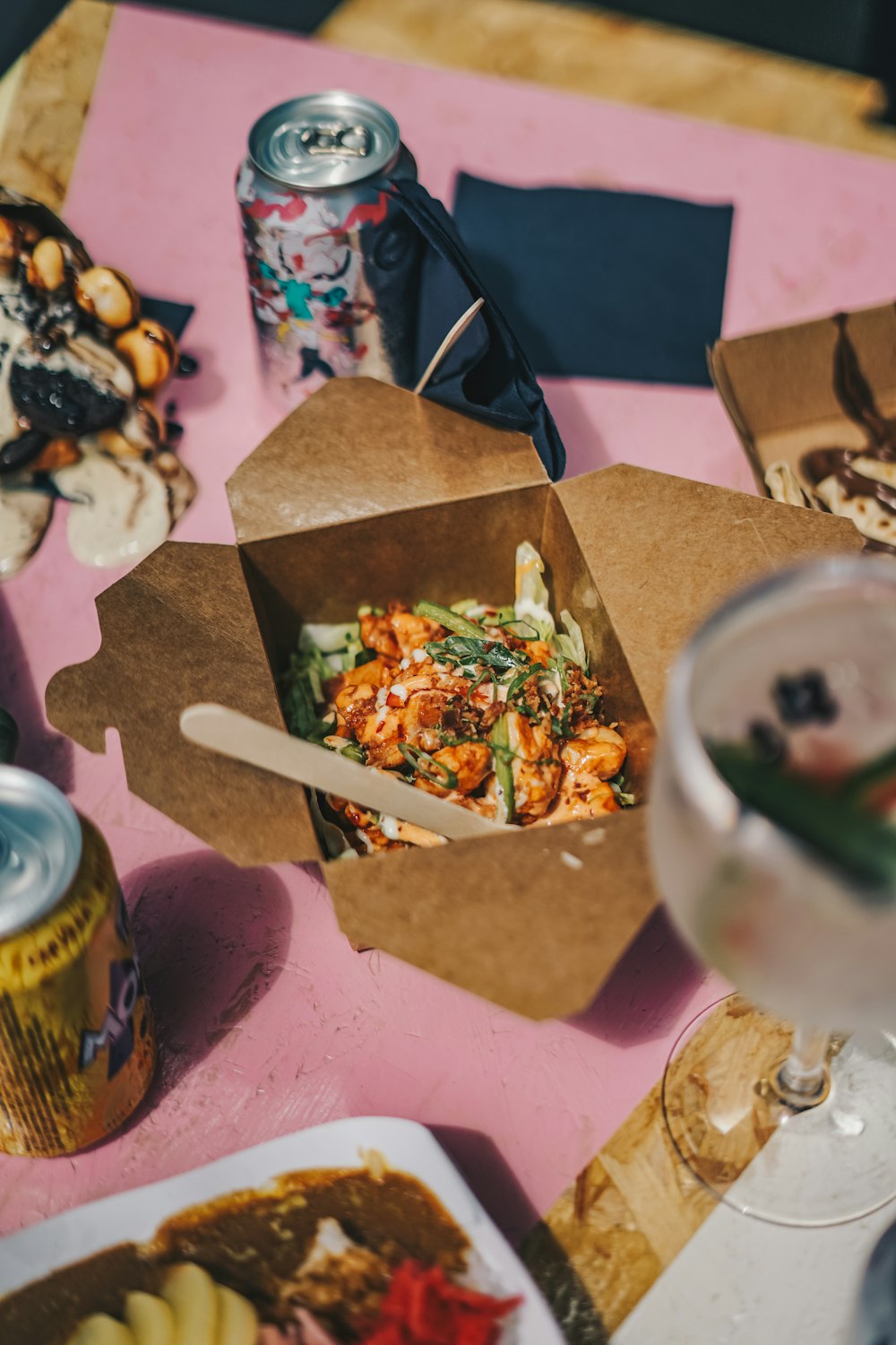 a table topped with boxes of food and drinks