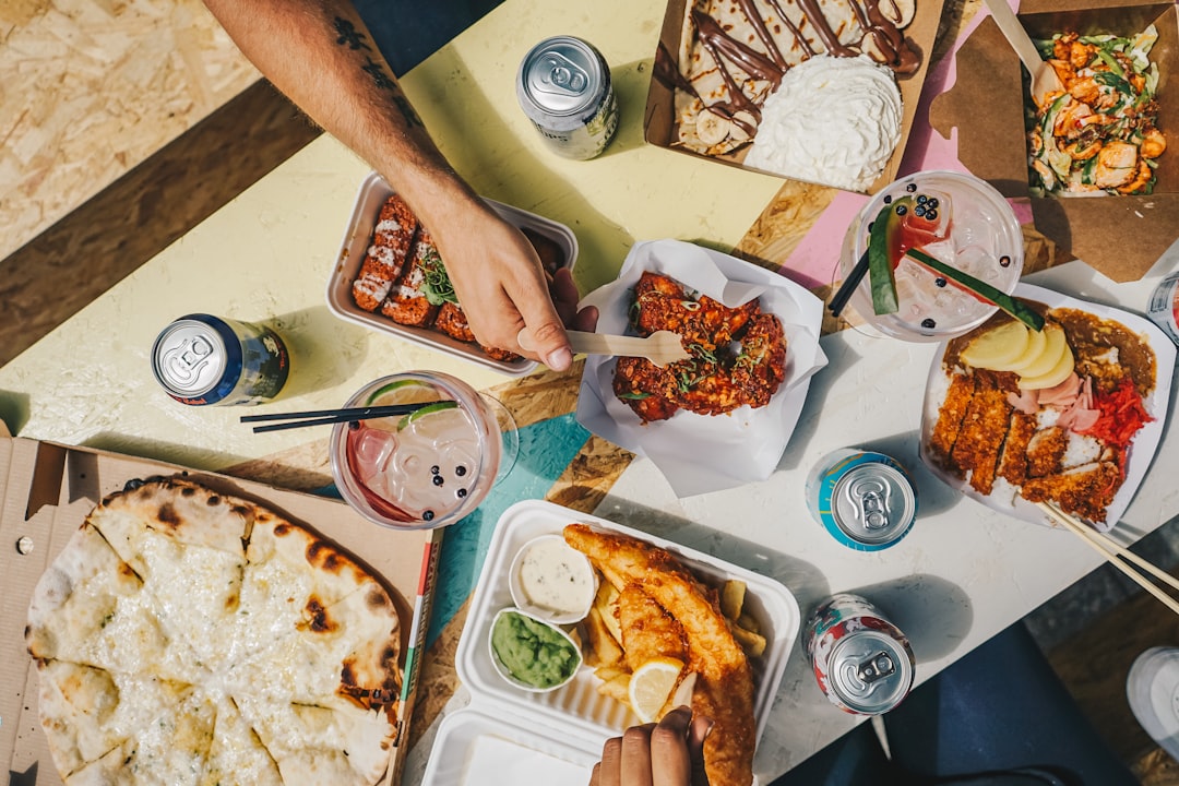 a group of people sitting around a table with food,