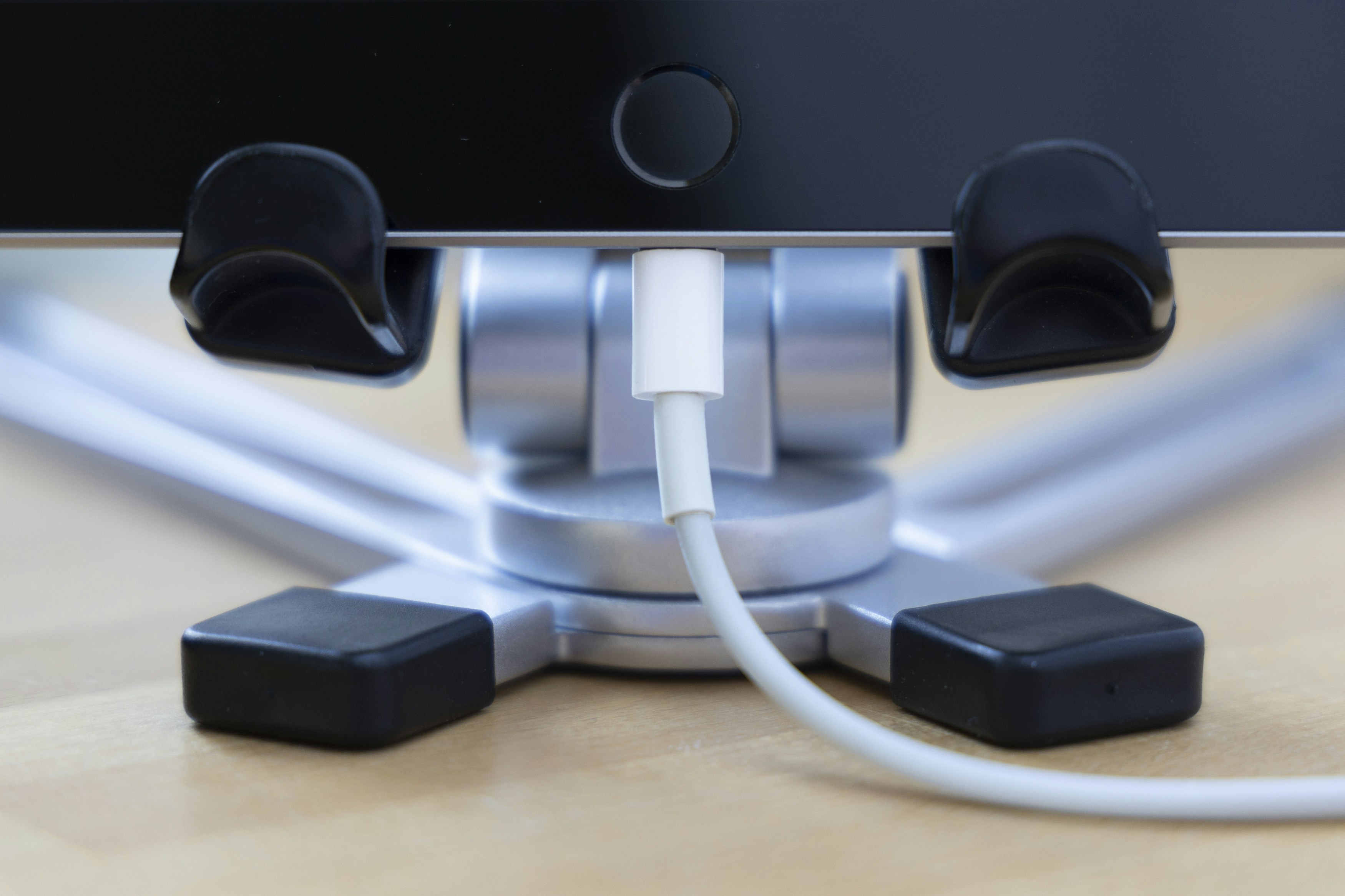 White charging cable connected to iPad dock base