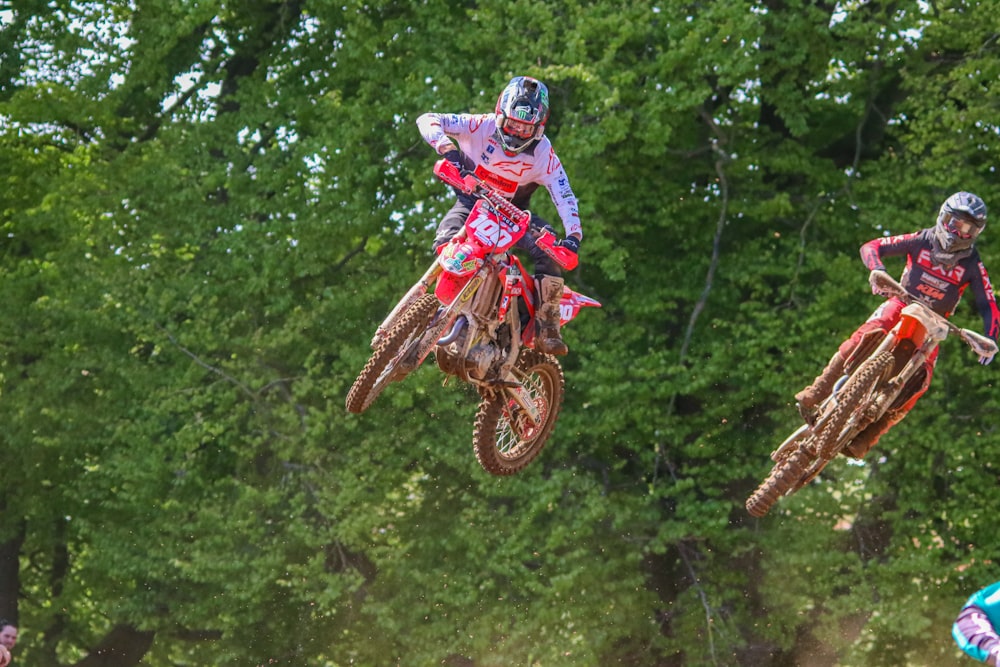 a couple of people on dirt bikes in the air