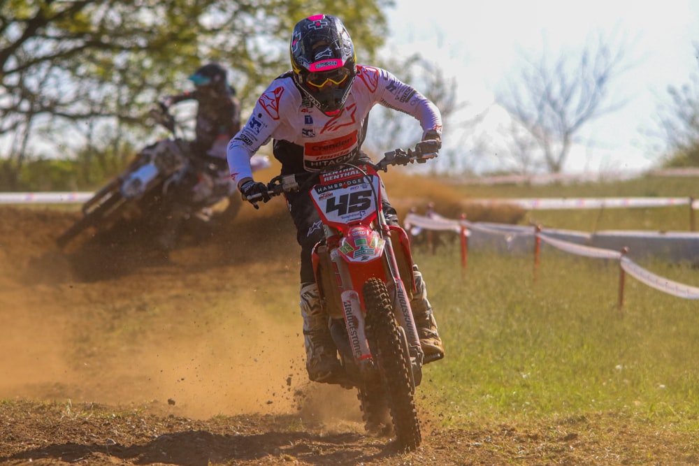 a man riding a dirt bike on top of a dirt field