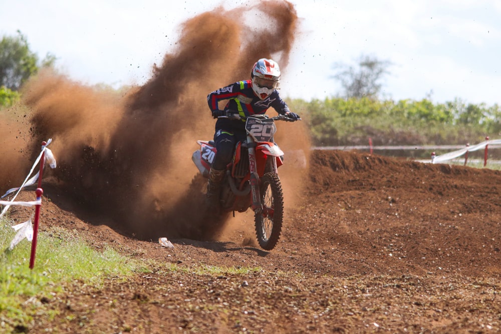 a man riding a dirt bike on top of a dirt field