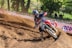 a person riding a dirt bike on a dirt track