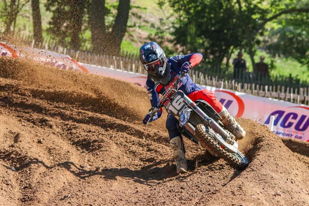 a person riding a dirt bike on a dirt track