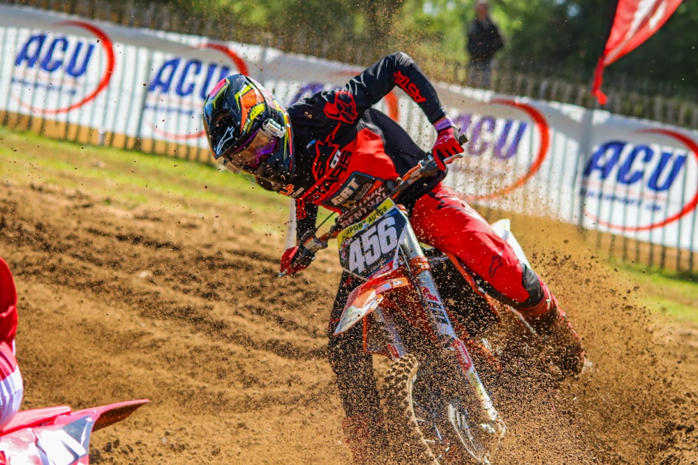 a man riding a dirt bike on top of a dirt field