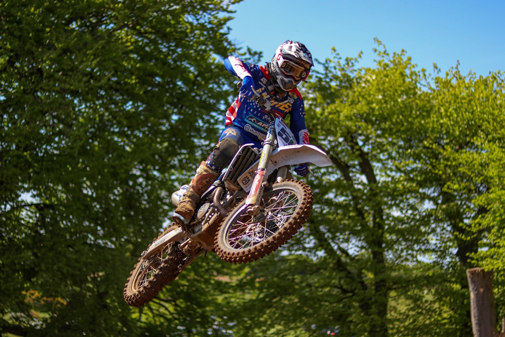 a man riding a dirt bike through the air