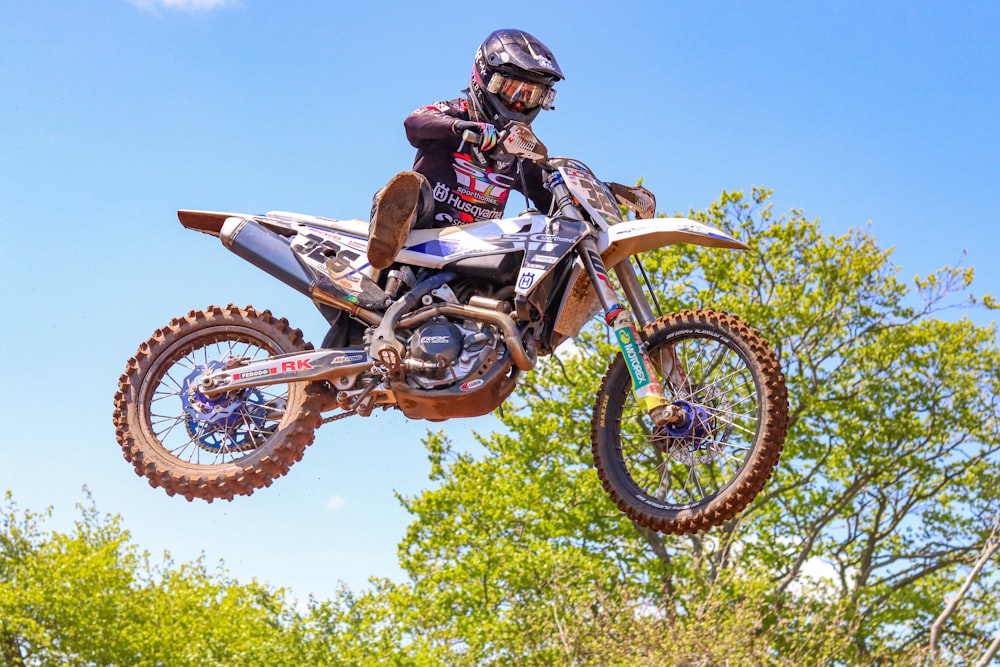 a man riding a dirt bike through the air