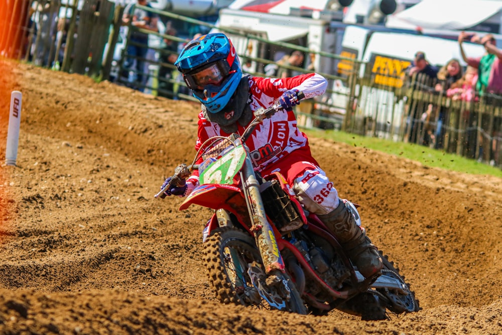 a man riding a dirt bike on top of a dirt field