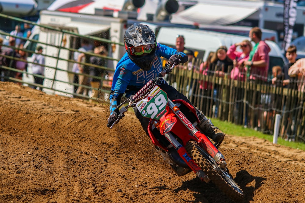 a man riding a dirt bike on top of a dirt field