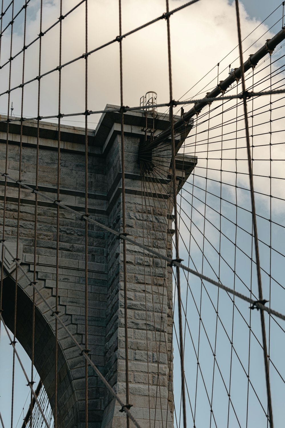 a view of a bridge through a wire fence