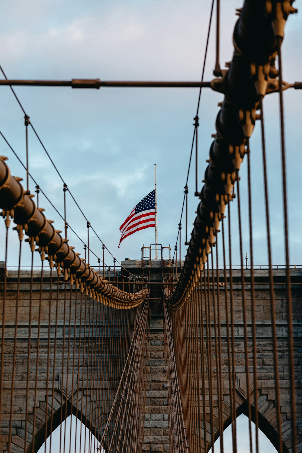 an american flag is flying on top of a bridge