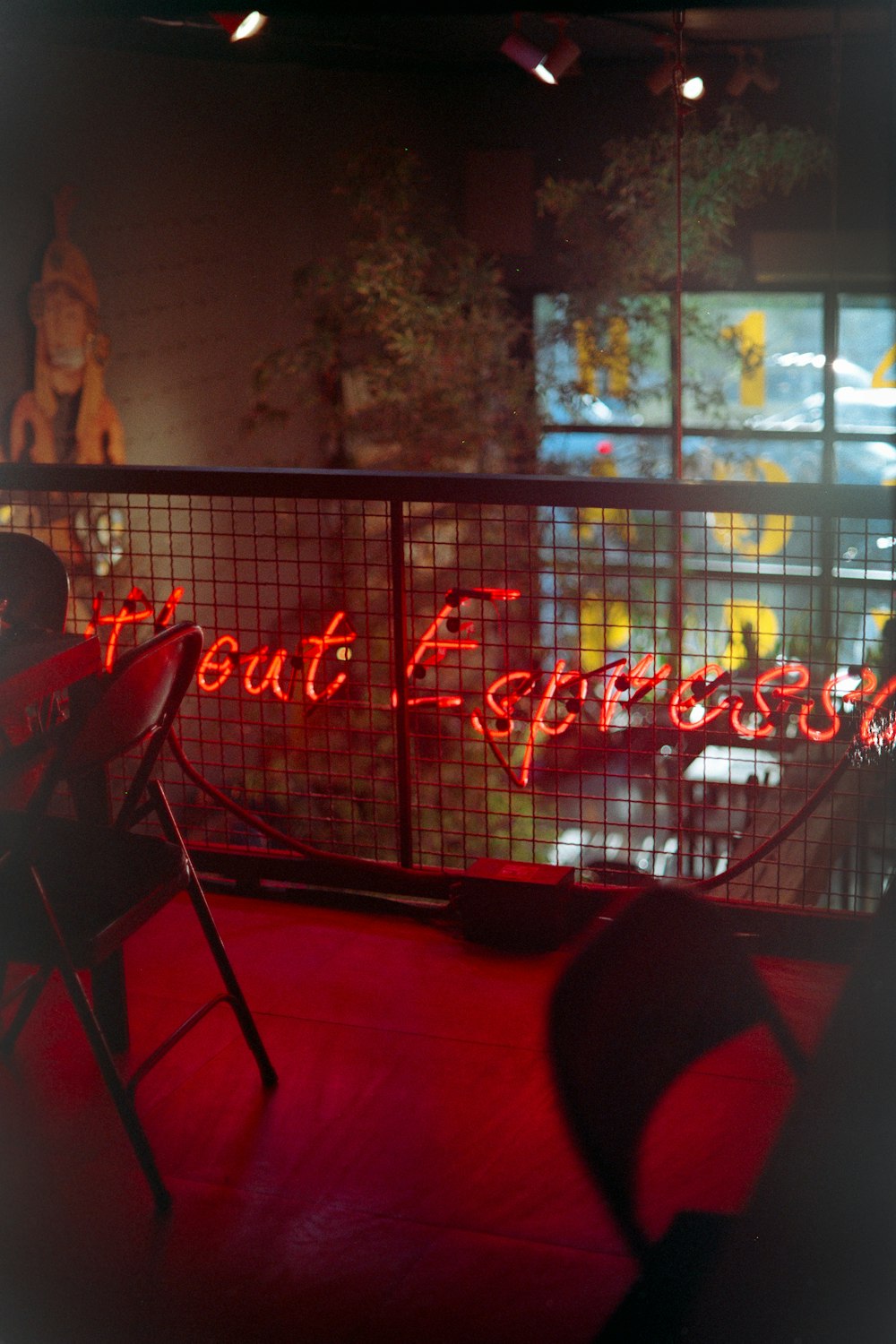 a red neon sign that reads meat express