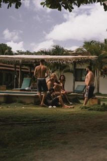 a group of people sitting around a pool