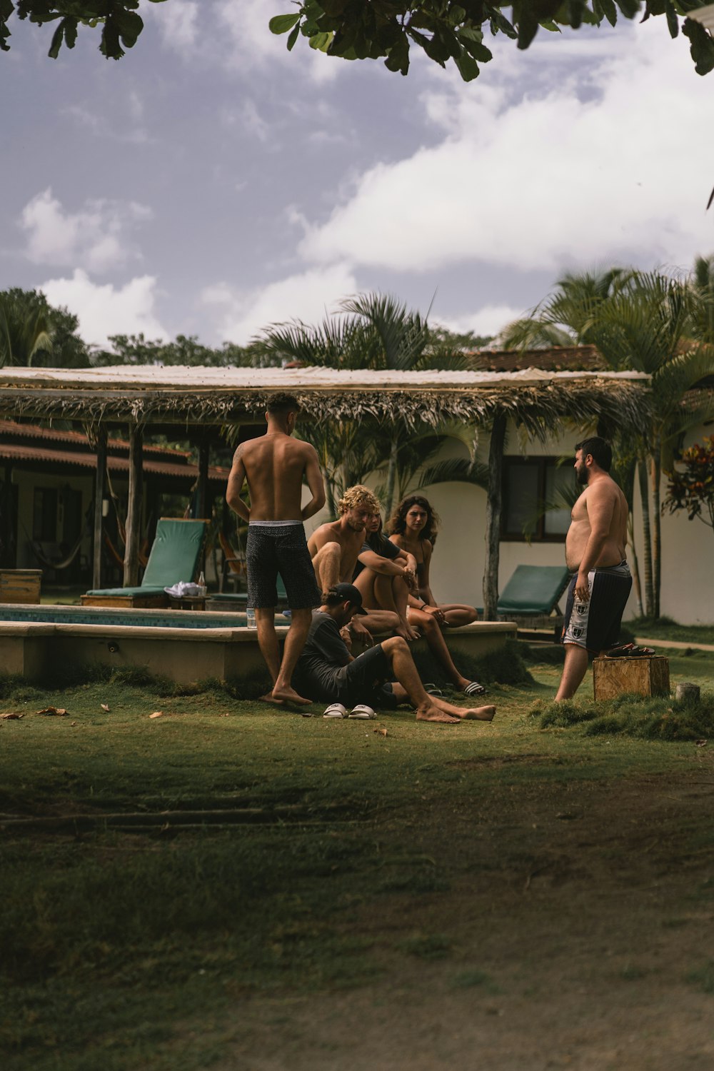 a group of people sitting around a pool