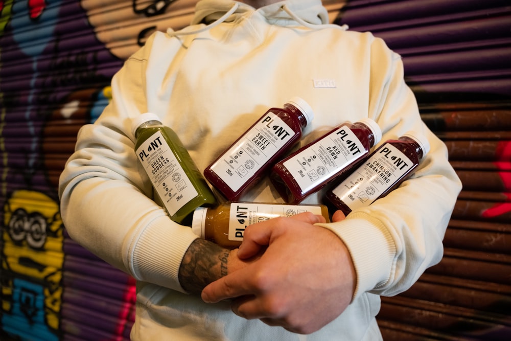 a person holding a bottle of ketchup in their hands