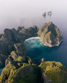 an aerial view of a body of water surrounded by rocks