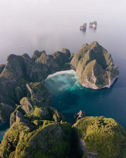 an aerial view of a body of water surrounded by rocks