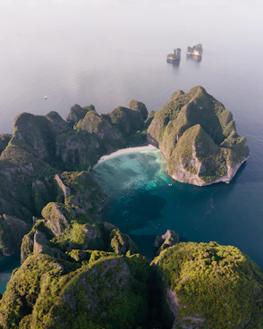 an aerial view of a body of water surrounded by rocks