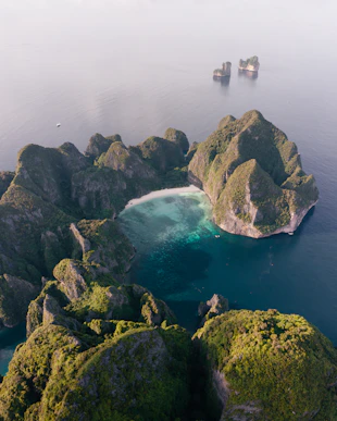 an aerial view of a body of water surrounded by rocks