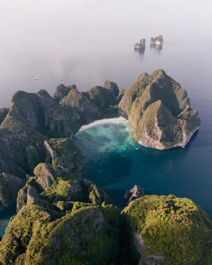 an aerial view of a body of water surrounded by rocks
