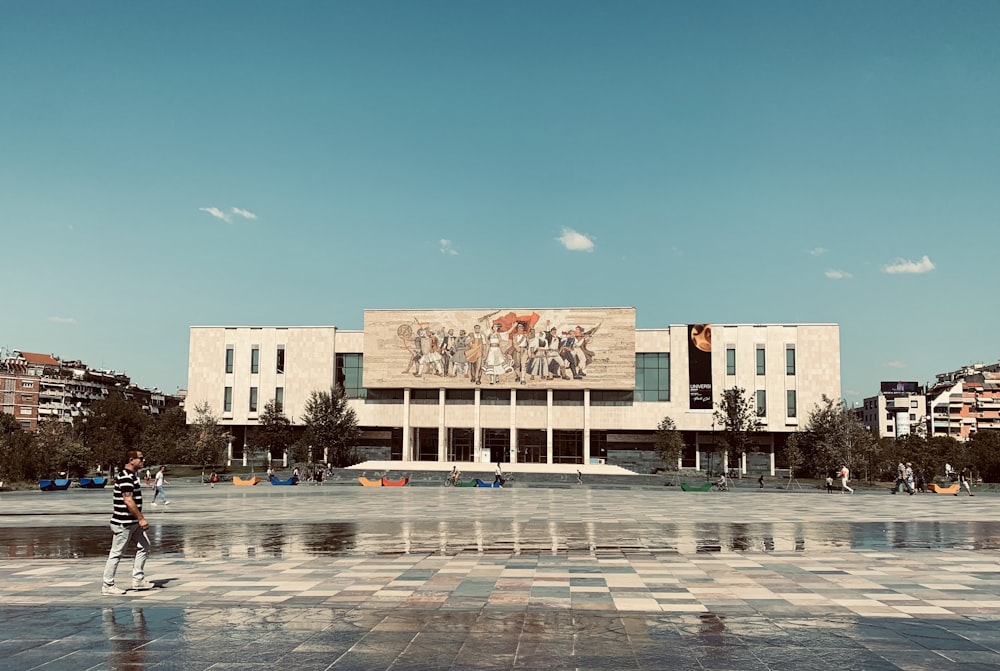 a person standing in front of a large building