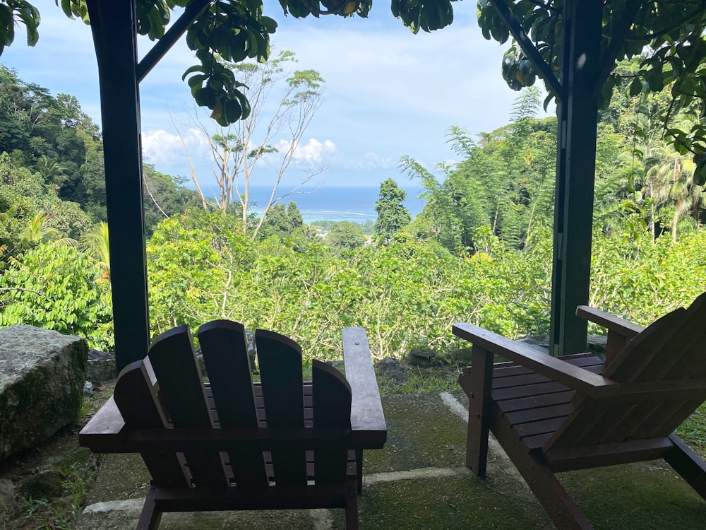 a couple of chairs sitting on top of a lush green field