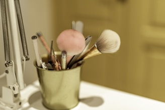 a cup filled with lots of makeup brushes