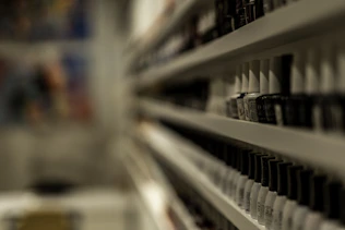 a close up of a shelf with a bunch of cups on it