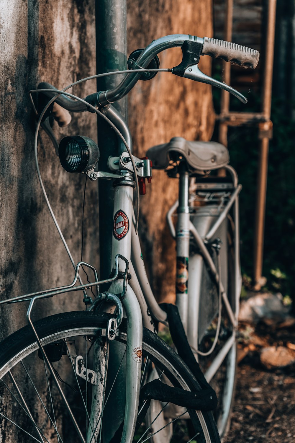 a close up of a bike parked next to a building