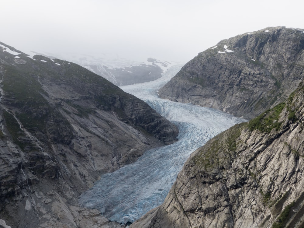 a large glacier in the middle of a mountain range