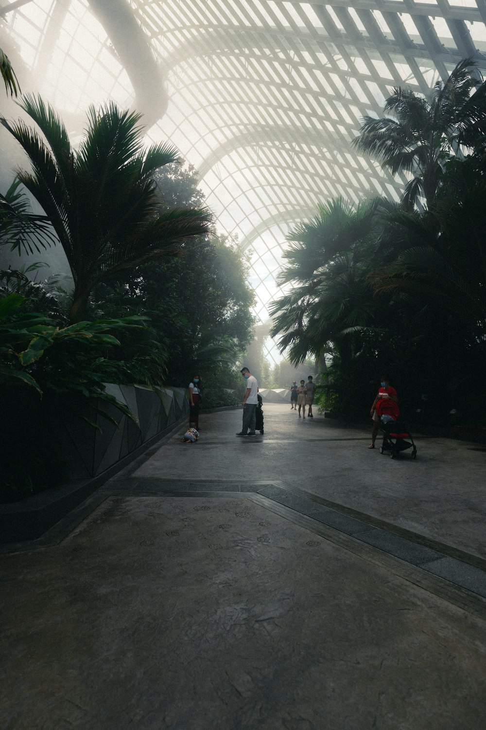 a group of people riding skateboards down a walkway