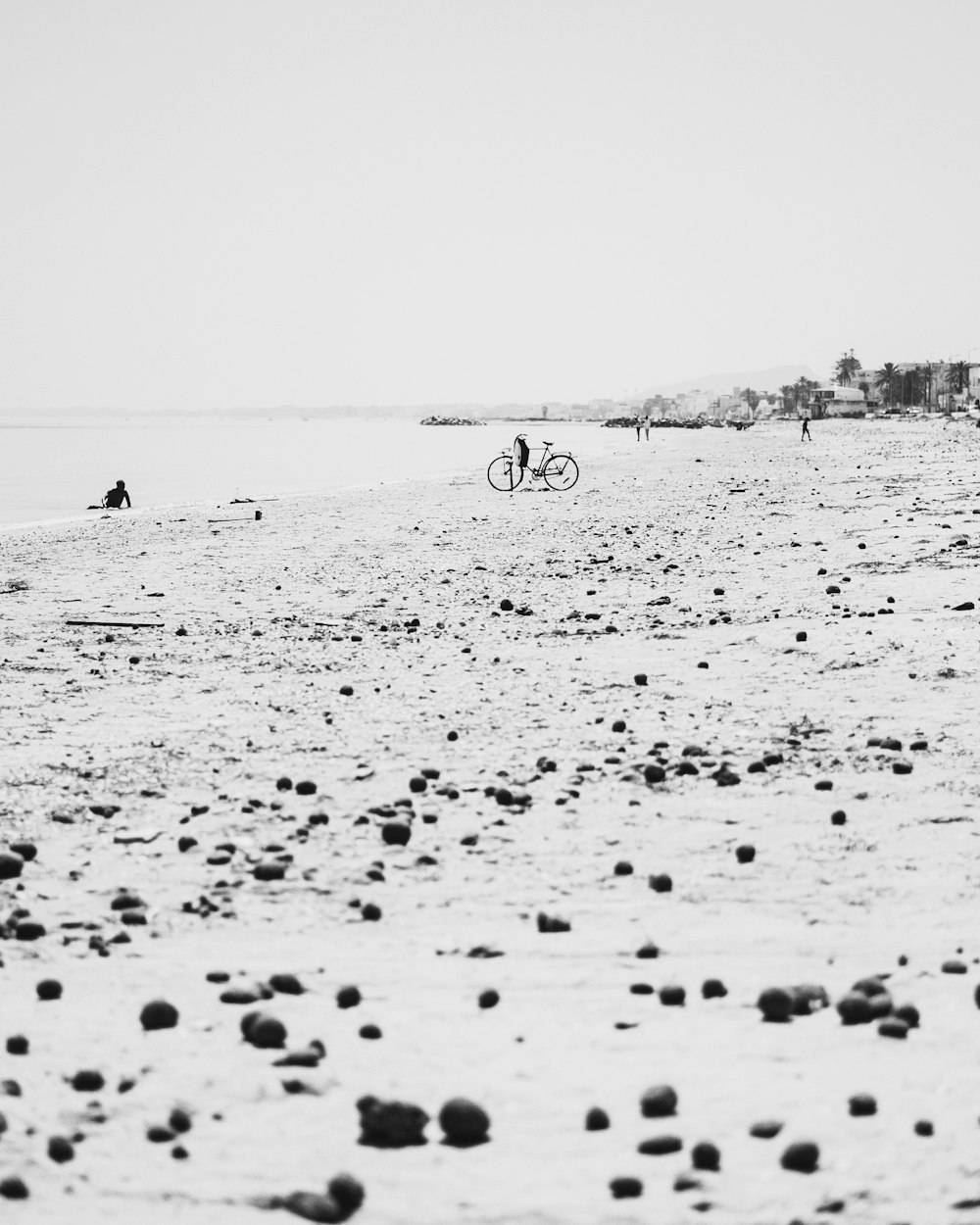 a black and white photo of people on a beach