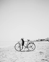 Vintage bicycle resting beside sand dunes on a golden Adriatic shoreline.