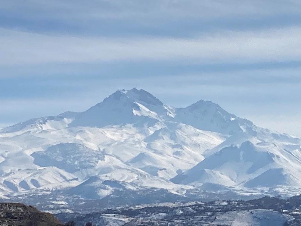 a snow covered mountain is seen in the distance