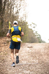 Runner wearing a hydration vest on a trail
