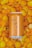 A can of pale ale labeled 'Sunday' with an alcohol content of 5.5% is placed on a surface covered with vibrant orange and yellow flower petals.