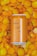 A can of pale ale labeled 'Sunday' with an alcohol content of 5.5% is placed on a surface covered with vibrant orange and yellow flower petals.