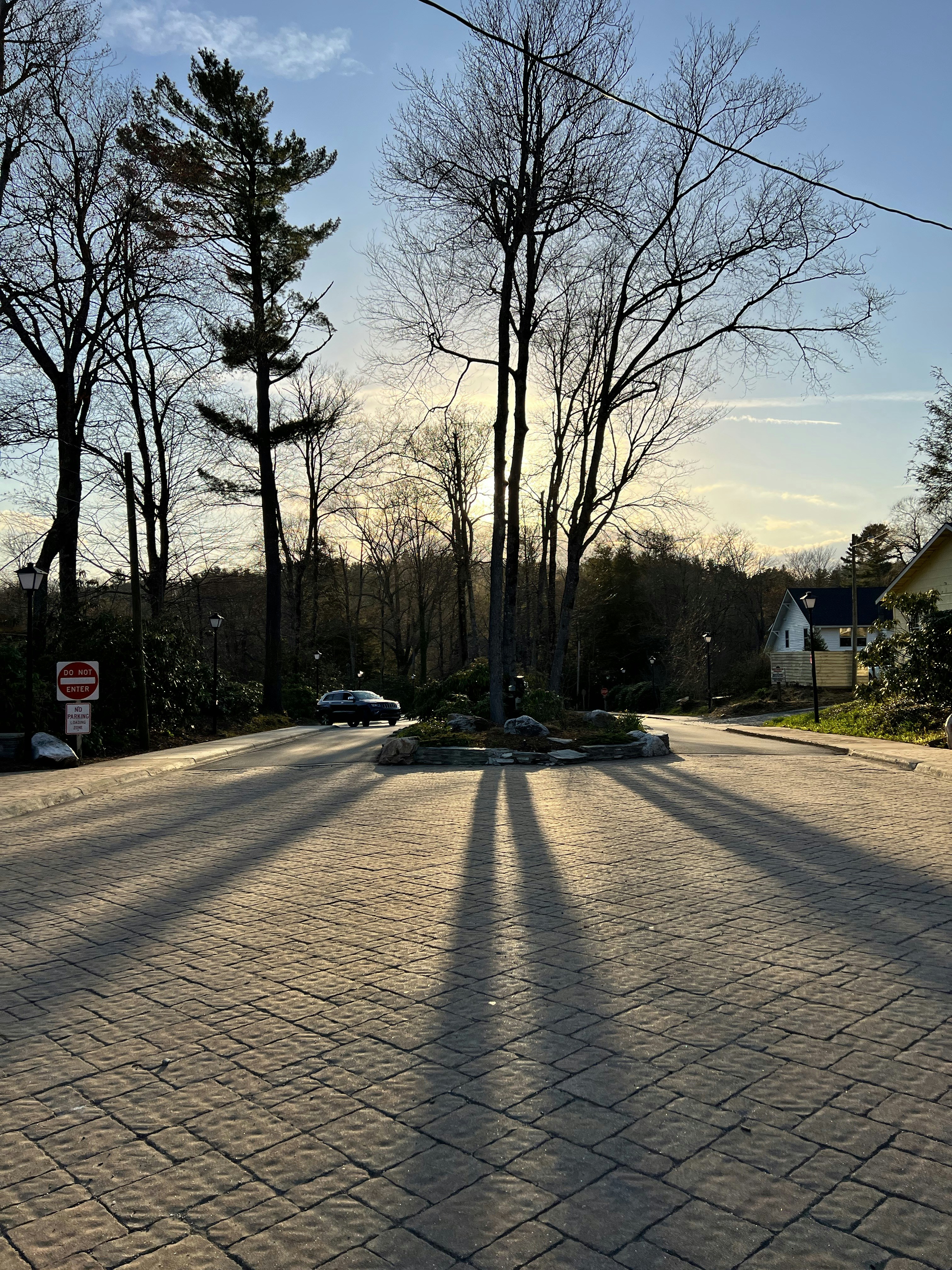 the shadow of a person riding a skateboard on a street