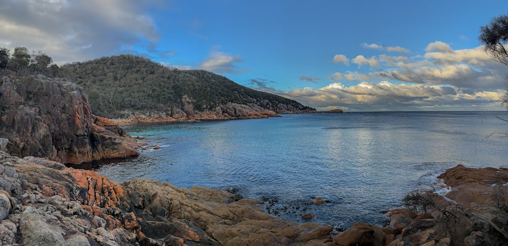 a body of water surrounded by rocks and trees