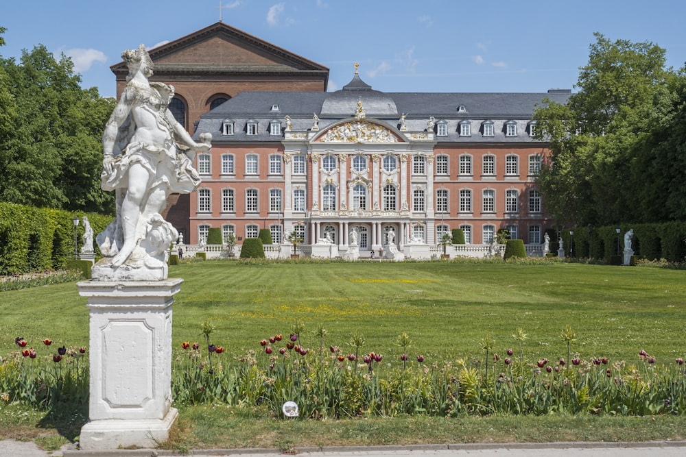 a large building with a statue in front of it