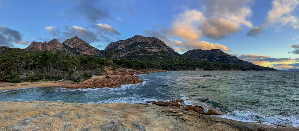 a beautiful view of some mountains and the ocean