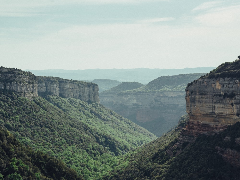 a scenic view of a valley and mountains