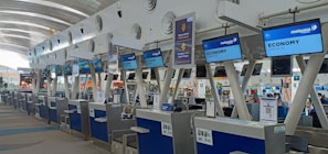 Our friendly staff assisting passengers at a bustling airport check-in counter in Malaysia