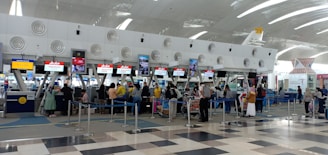 a group of people waiting in line at an airport