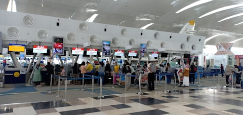 a group of people waiting in line at an airport